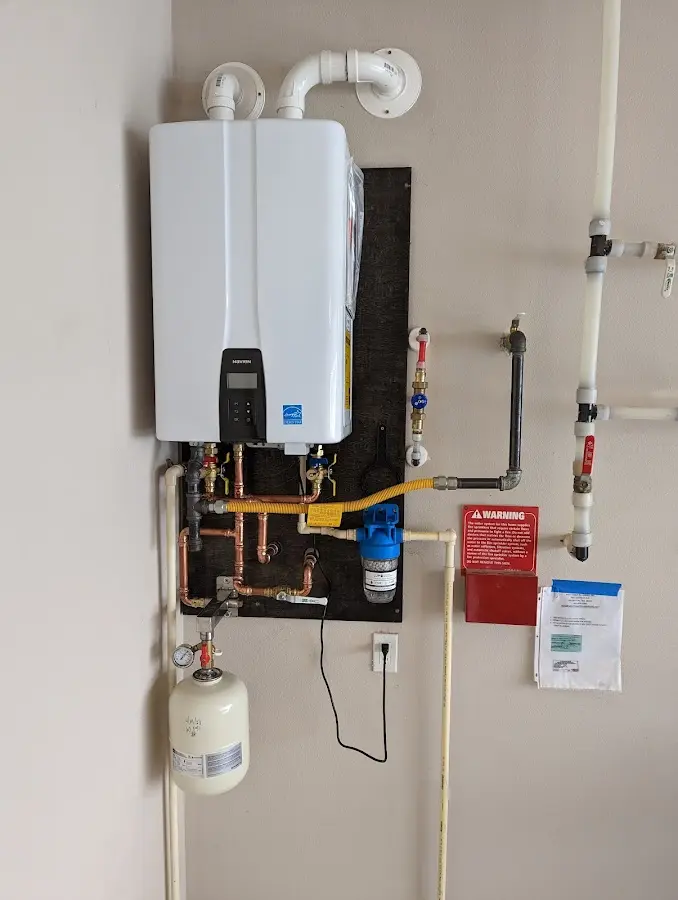 Professional plumber installing copper piping in a Tuba City home